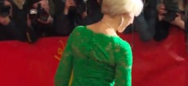 Helen Mirren trips up a step wearing skin tight emerald green dress (Video)